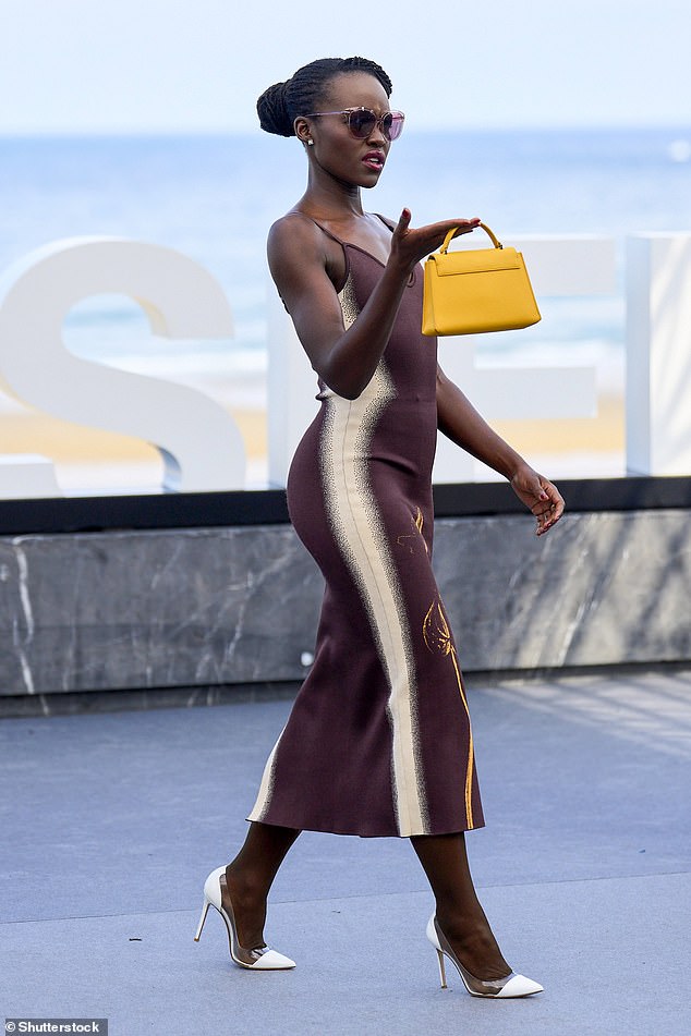 Lupita turned heads as she took to the stage, wearing pink cat-eye sunglasses and a mustard mini bag to carry her outfit