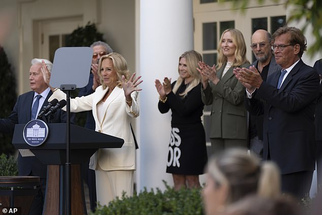 Dr. Jill Biden addresses the Rose Garden crowd on Friday while surrounded by cast members and West Wing creator Aaron Sorkin (right)