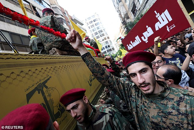 A man makes a gesture during the funeral of Hezbollah leader Ibrahim Aqil