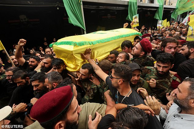 Relatives carry a coffin during the funeral of Hezbollah leader Ibrahim Aqil and Hezbollah member Mahmoud Hamad