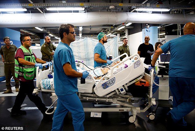 Medical staff move a patient's bed into an underground makeshift hospital in a parking lot at the Rambam Health Care Campus, amid cross-border hostilities between Hezbollah and Israel, in Haifa, Israel, September 22, 2024