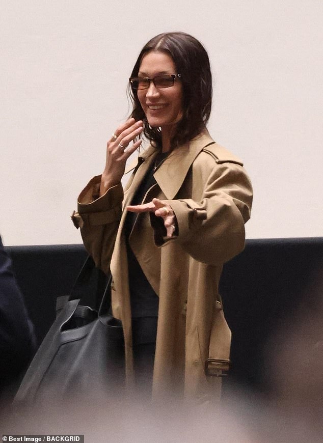 The model touched down in Paris ahead of the start of fashion week and was spotted later in the day with her hair down and smiling as she walked through the city