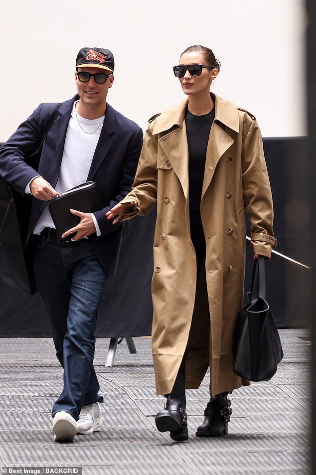 The brunette beauty added a pair of chunky biker boots to her off-duty look and carried a large black bag as she chatted with a friend