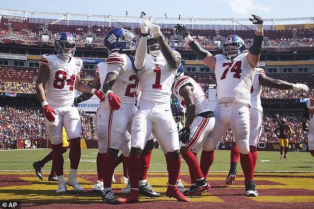 Nabers and his teammates celebrate one of his two touchdowns in the first half against the Browns