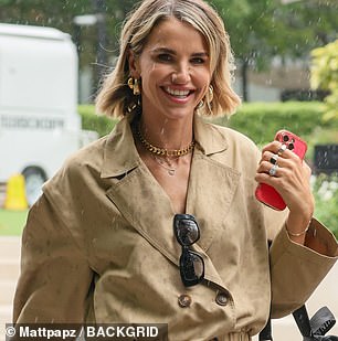 She kept her makeup natural and wore a pair of small hoop earrings as she let her short blonde locks flow loose in the wind.