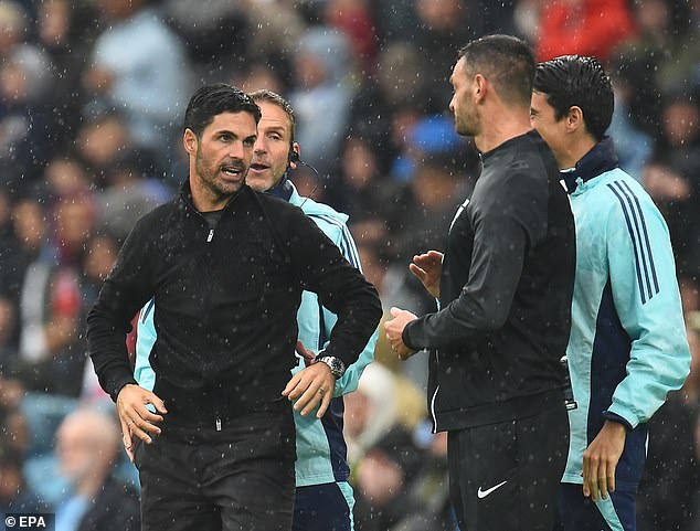 Arteta (left) criticised the red card for Leandro Trossard for slowing down play after kicking the ball away – but he did not show a yellow card to City's Jeremy Doku, who appeared to do the same