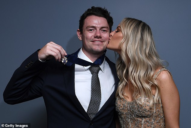 Lachie Neale's wife Julie kisses him on the cheek after the Lions midfielder makes the 2020 Brownlow count