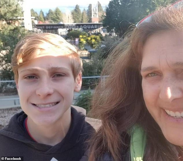 The teenager (pictured with his mother) died on the way to hospital after alerting a family member