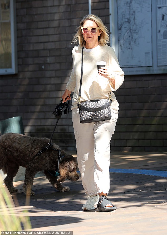 The star was seen wearing a 'post-surgery' shoe on her left foot while walking her dog