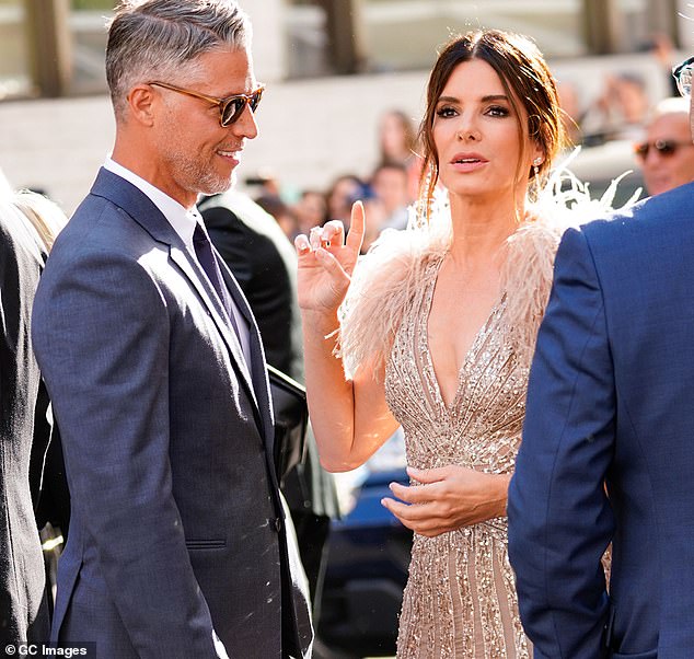 ALS also claimed the life of Sandra Bullock's partner Bryan Randall last year (pictured with Sandra Bullock in 2018)