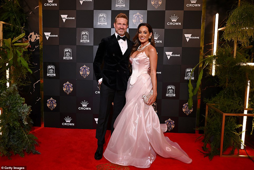 Brodie Ryan, partner of AFL legend Nathan Buckley, also made a splash on this year's red carpet in a full baby pink corset dress with pearls and a statement bird bag