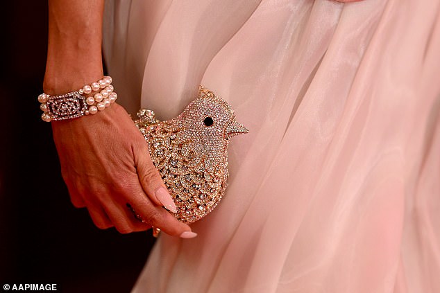 She paired her look with a charming bird bag