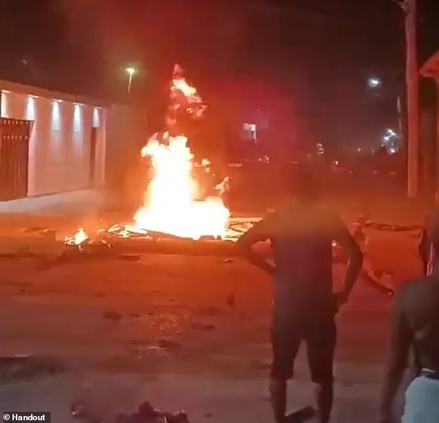 Residents of Jutaí stand by the burning body of Gregorio da Silva, who was set alight by an angry mob last Thursday night