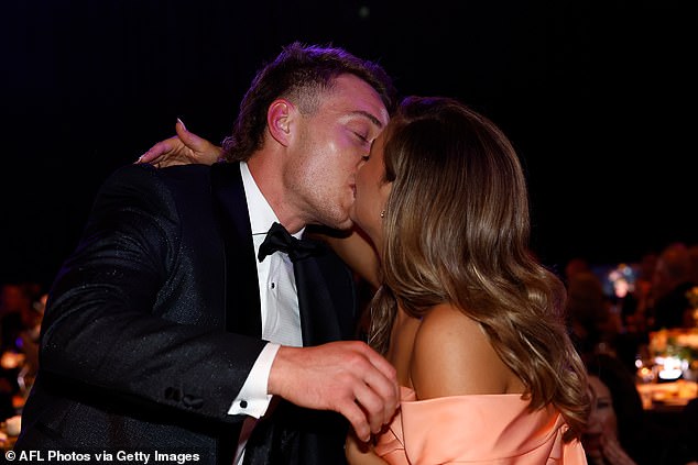 Cripps is kissed by his wife Monique after being announced winner of the prestigious award