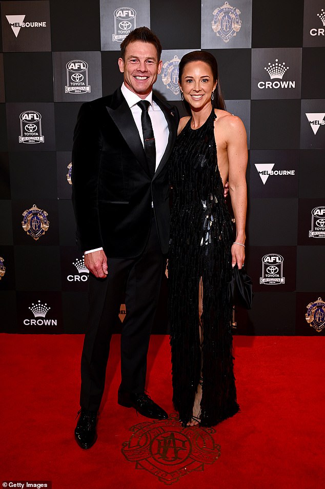 The former West Coast Eagles superstar, 46, was snapped looking healthy and happy as he proudly posed with his date for the night, along with his sister Melanie (left).