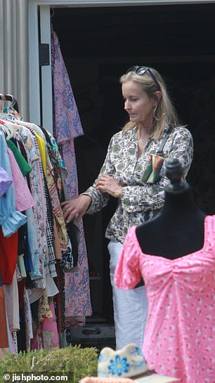 Bo was seen looking at a bright pink floral silk robe on a clothes rack that she later purchased