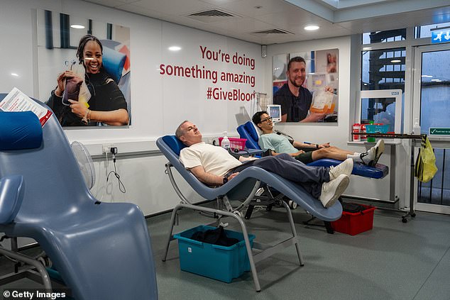 Above, two men donate blood at the West End Donor Centre in London, England in July