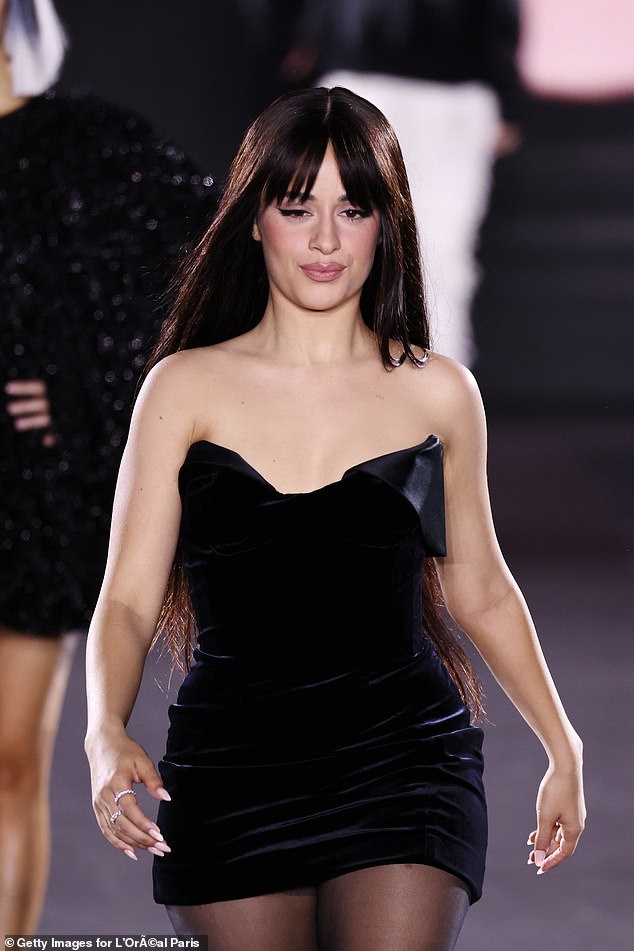 The 27-year-old singer slipped into a strapless black velvet mini dress as she stepped out confidently at the iconic event