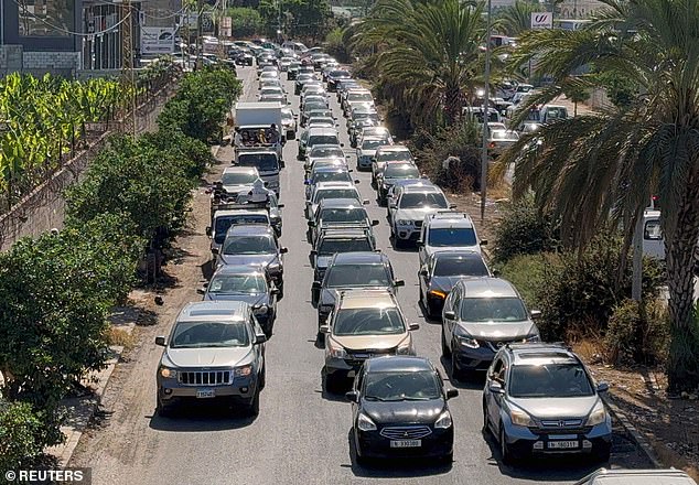 Cars flee north from Lebanon's southern coastal city of Sidon after Israeli bombardments