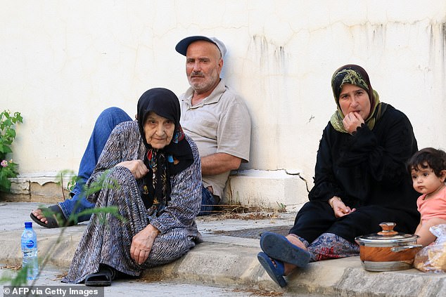 A Lebanese family who fled their village in southern Lebanon took refuge in a public school in Sidon on September 23