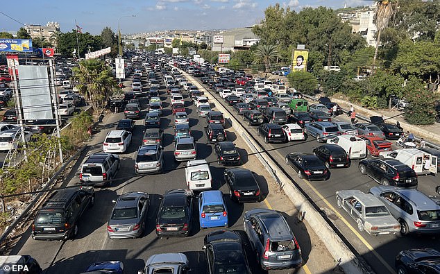 Lebanese flee in their cars from southern Lebanon towards Sidon and Beirut, via the Zahrani-Nabatieh road in Ghazieh, southern Lebanon, September 23