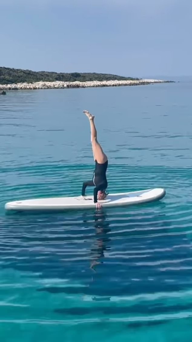 Paul McCartney's ex-wife Heather Mills does a headstand on a paddleboard while on vacation