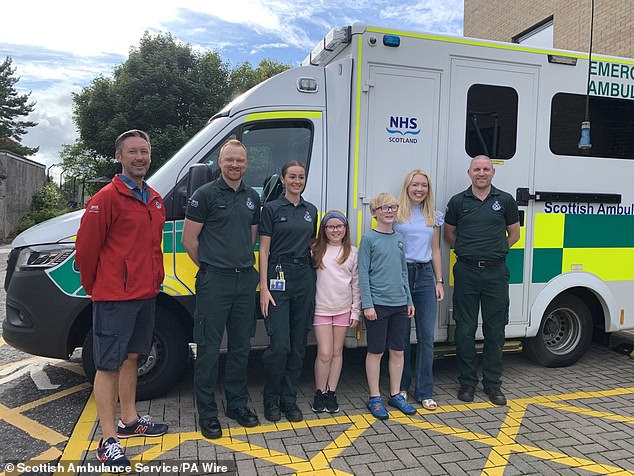 Scottish Ambulance staff with Arianna Liddle (centre), her brother Oliver (centre right) and their mother, Donna (second from right)