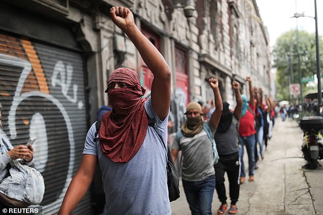 Students march through the streets of Mexico City, near the Interior Ministry, calling on the government of President Andrés Manuel López Obrador to respond to the disappearance of 43 students.