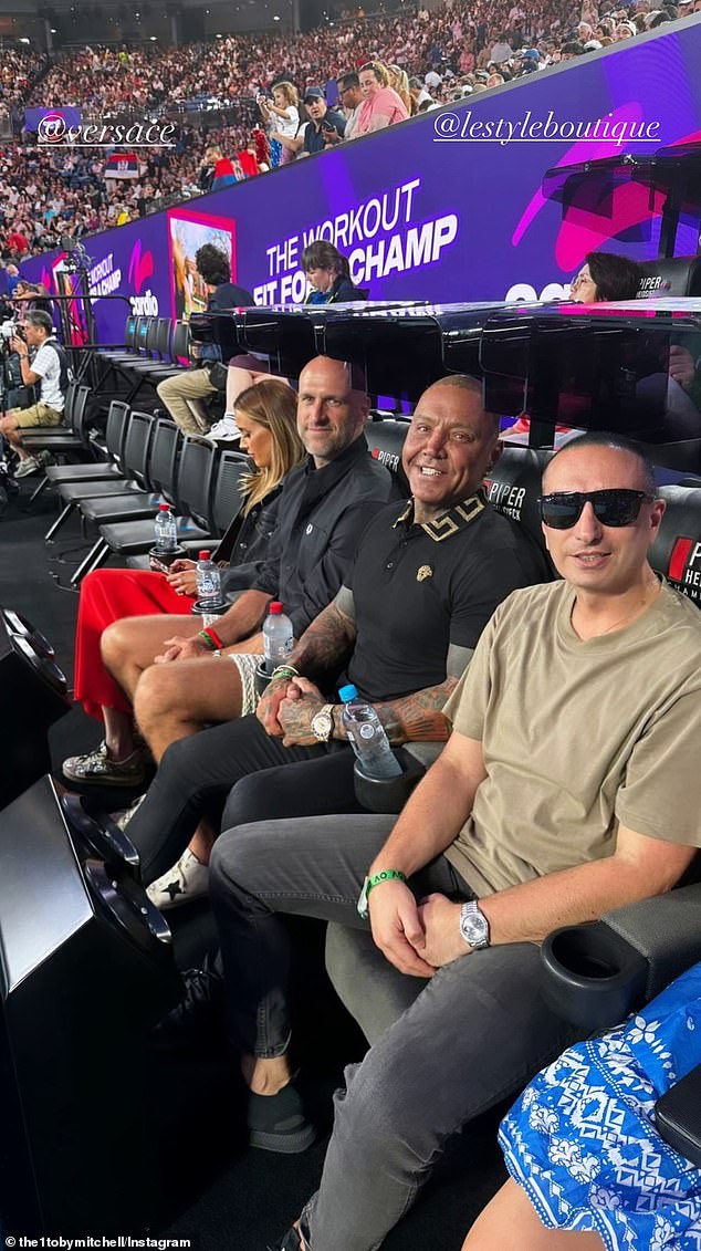 Toby Mitchell was photographed in January at the Australian Open tennis tournament, sitting on the courtside chairs next to Bec and Chris Judd