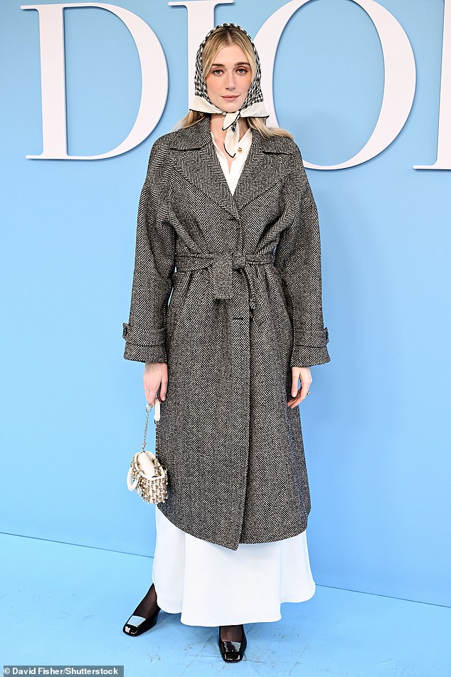 Elizabeth Debicki opted for a layered look as she appeared to wear a simple white midi dress underneath a chunky gray tweed coat