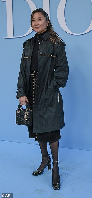 Emily In Paris star Ashley Park looked stylish in a black trench coat and a black zip-up skirt