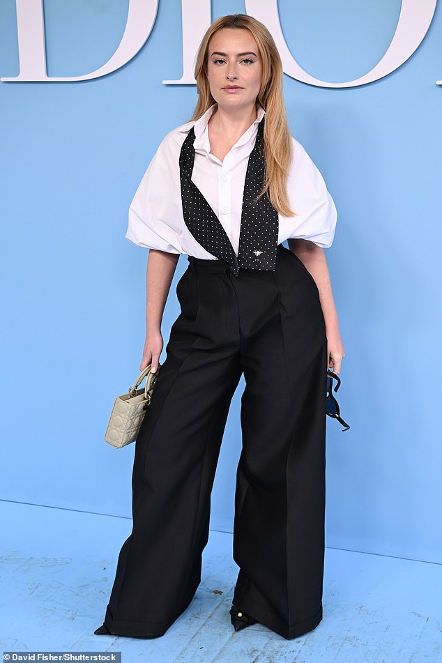 Amelia Dimoldenberg looked stunning in a white open collar shirt, a white black polka dot tie and black wide leg trousers