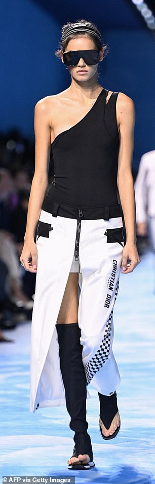 Another wore a race car-inspired white skirt with a high slit and black toeless boots