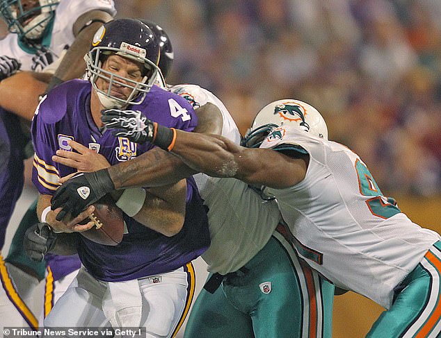 Minnesota Vikings quarterback Brett Farve is sacked by Miami Dolphins defenders in 2010