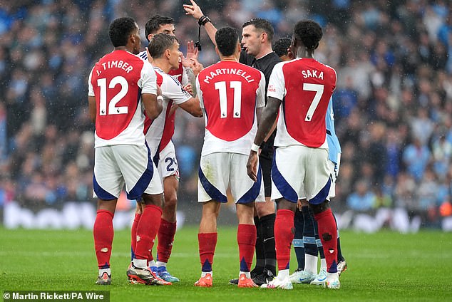 The Gunners were furious at Michael Oliver's decision to sack Leandro Trossard (second left) for delaying the restart