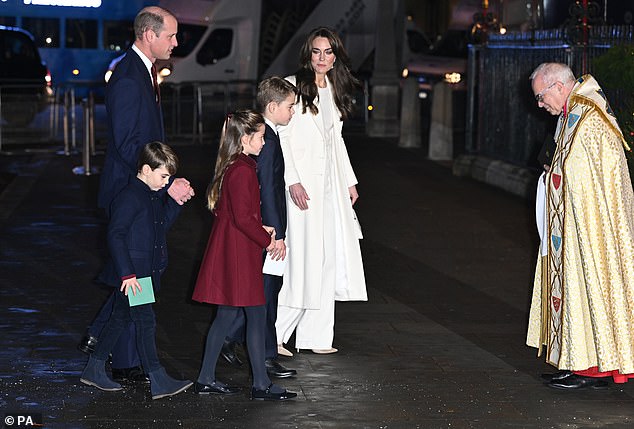 The Prince of Wales, Prince Louis, Princess Charlotte, Prince George and The Princess of Wales are greeted by the Dean of Westminster ahead of the Christmas Service in December 2023