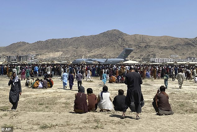 Hundreds of people gather near a U.S. Air Force C-17 transport plane on the outskirts of the international airport in Kabul, Afghanistan, on August 16, 2021