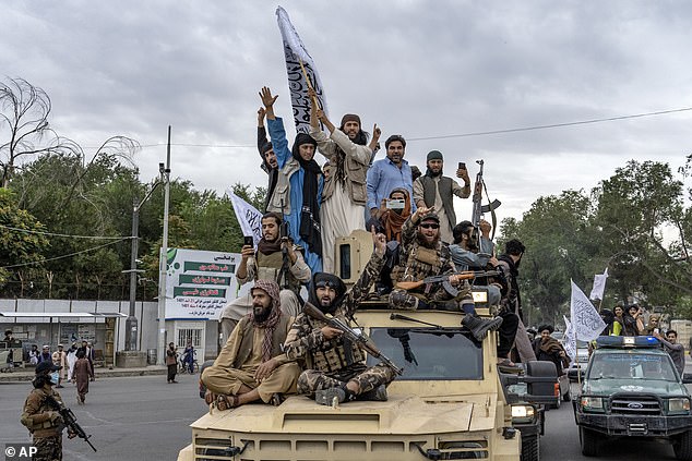 Taliban fighters celebrate the one-year anniversary of the capture of the Afghan capital Kabul, in front of the U.S. Embassy in Kabul, Afghanistan, Monday, Aug. 15, 2022