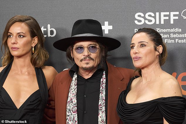 Depp appeared on the red carpet in a black shirt with a white scarf over his shoulders