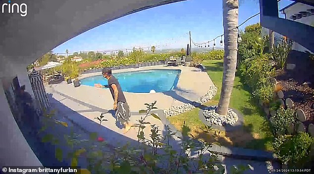 The clip shows a man who looks like a skilled musician running quickly through the backyard