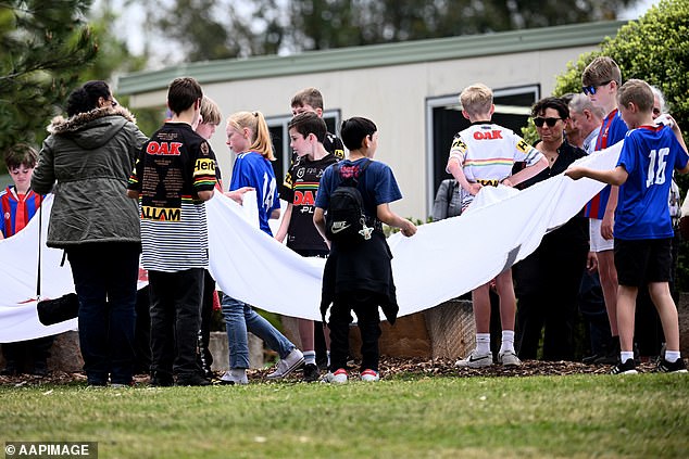 Young mourners are pictured at the funeral of Russell, 11, and Ben, 9, on Wednesday morning at St Thomas Aquinas Catholic Church in Springwood