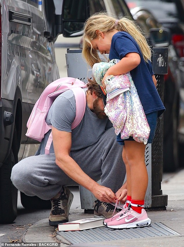 At one point, the Maestro star crouched down to tie the laces on seven-year-old Lea's pink Nike sneaker