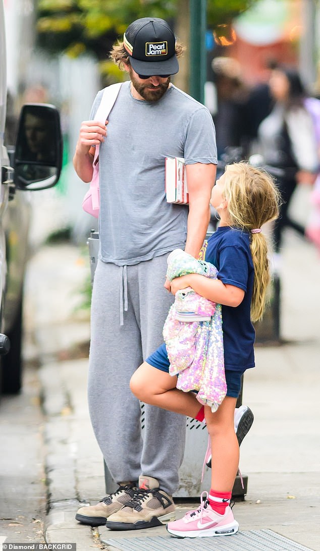 Cooper was dressed comfortably in a plain gray T-shirt and matching sweatpants