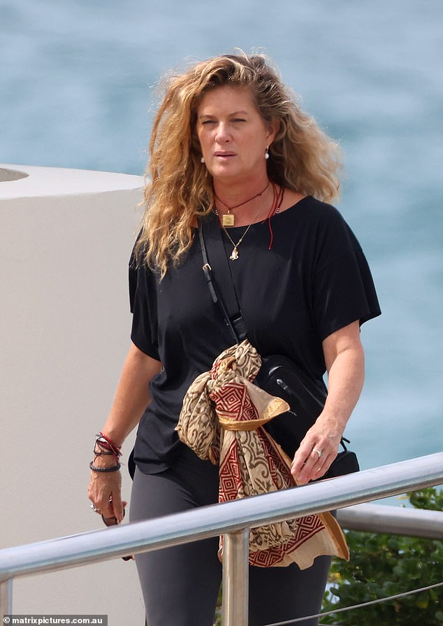 The New Zealand model and actress looked much younger than her 55 years as she walked along the coast in gray leggings and a black blouse