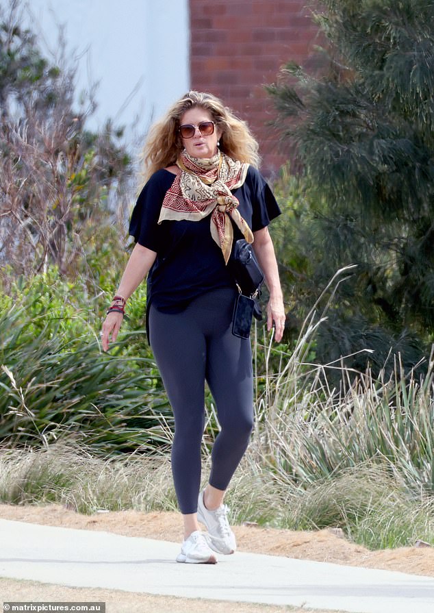 She also wore a variety of colorful necklaces and a brightly patterned scarf tied around the strap of her bag.