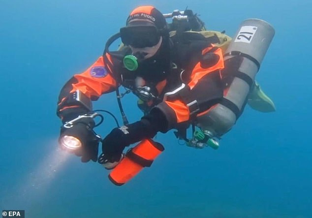 Italian divers inspect the wreck of the Bayesian yacht off the coast of Sicily on August 23