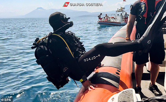 A diver enters the water off the coast of Sicily on August 23 as the team conducts an inspection