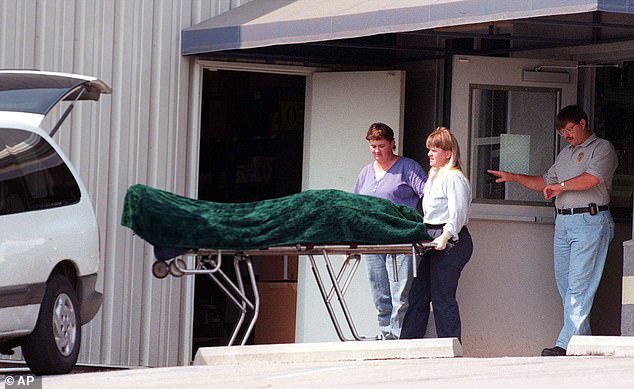 A body is removed from the crime scene after Miller opened fire