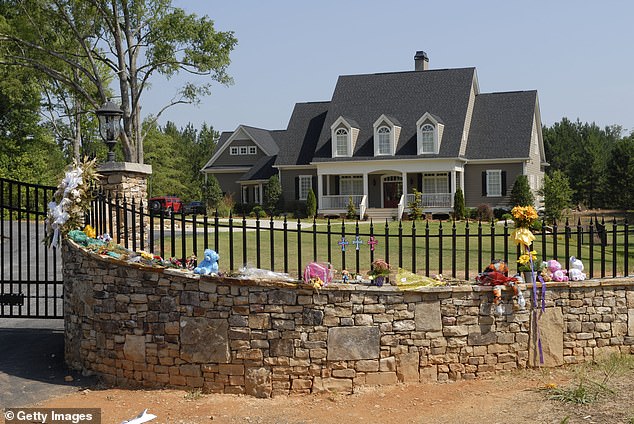 A makeshift shrine adorns the fence of professional wrestler Chris Benoit's home July 1, 2007