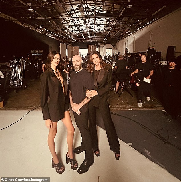 The 58-year-old 90s supermodel, who has a whopping 13.4 million followers on social media, shared a sneak peek of BTS snaps from the set alongside director David Lowery (M), captioning the photo: 